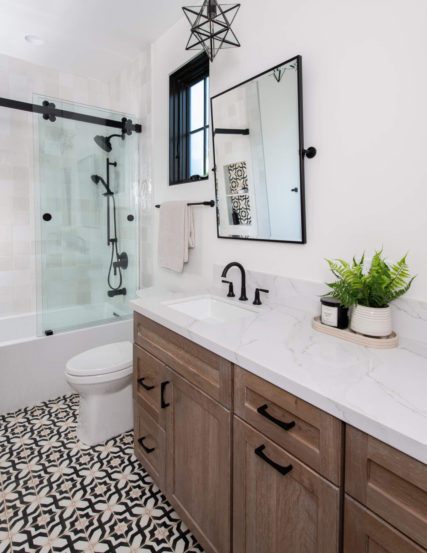 Modern farmhouse bathroom remodel in Marietta with oak vanity and patterned floor