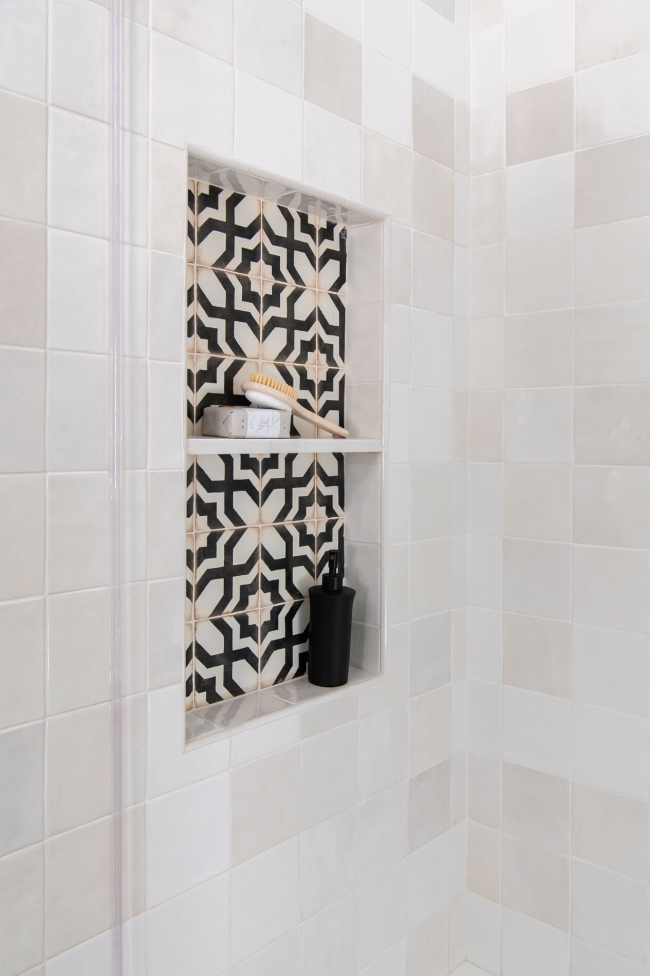 Shower niche with patterned cement tile back and zellige surround