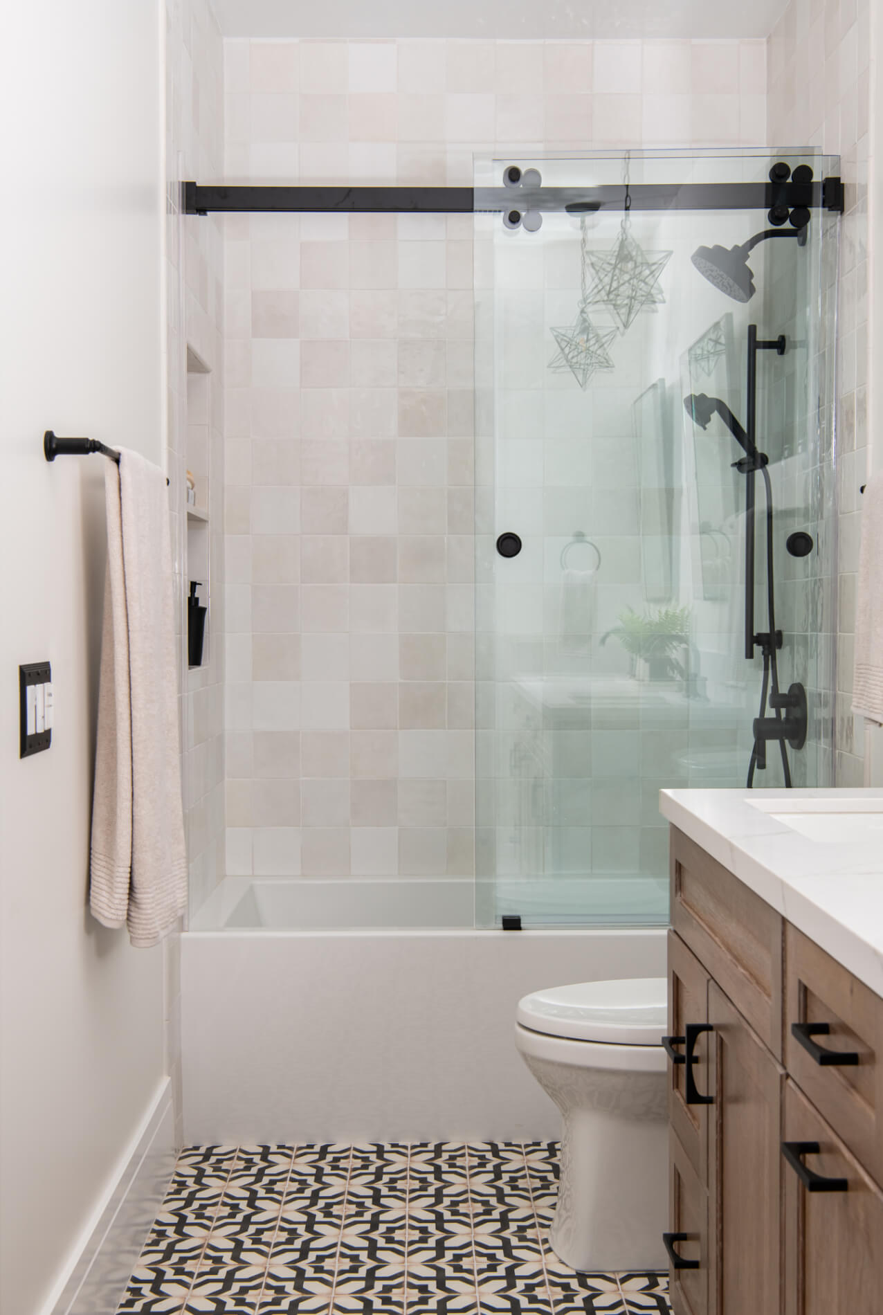 Tub-shower combo with glass enclosure and blush zellige