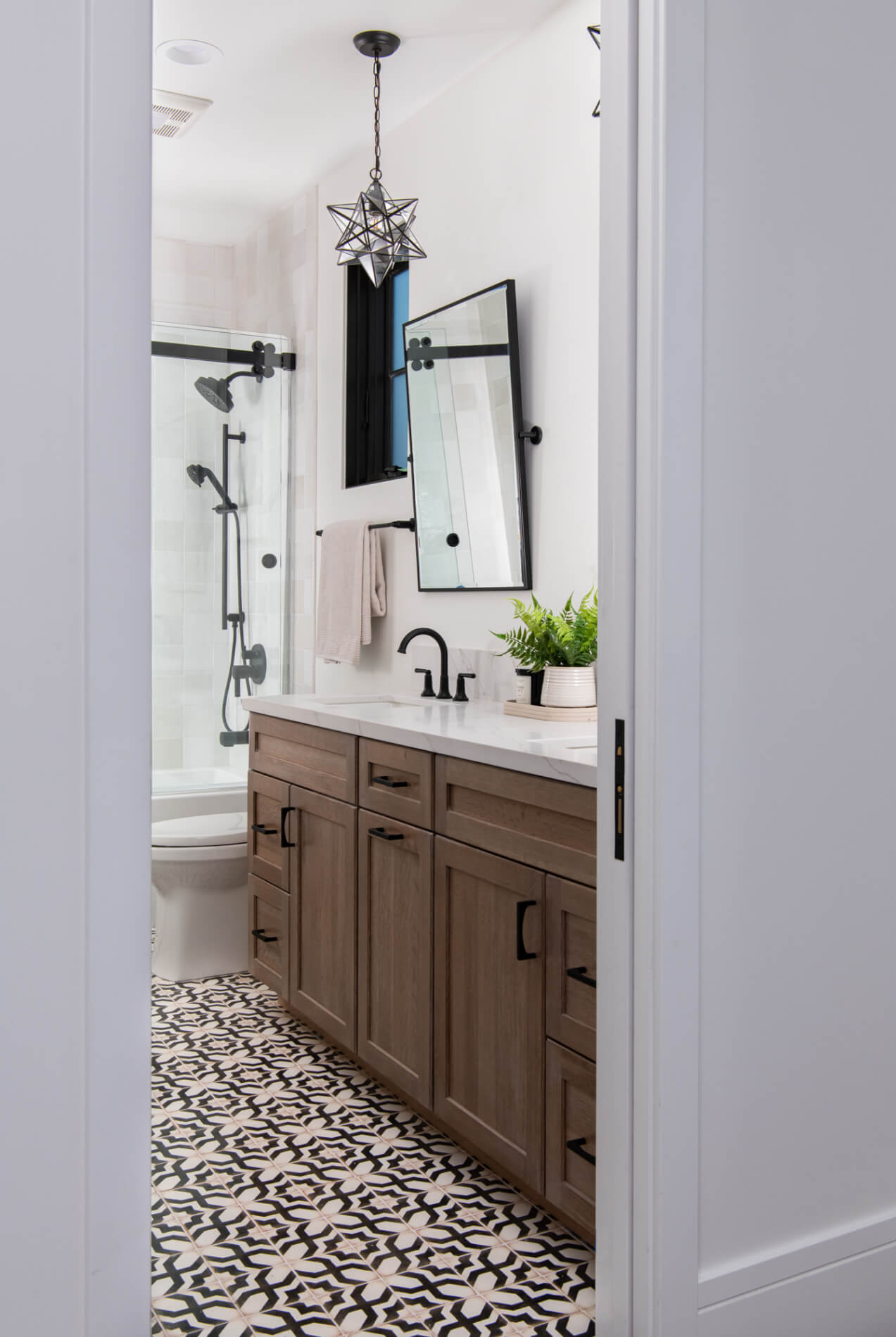 Wide doorway view with shower vanity and patterned floor