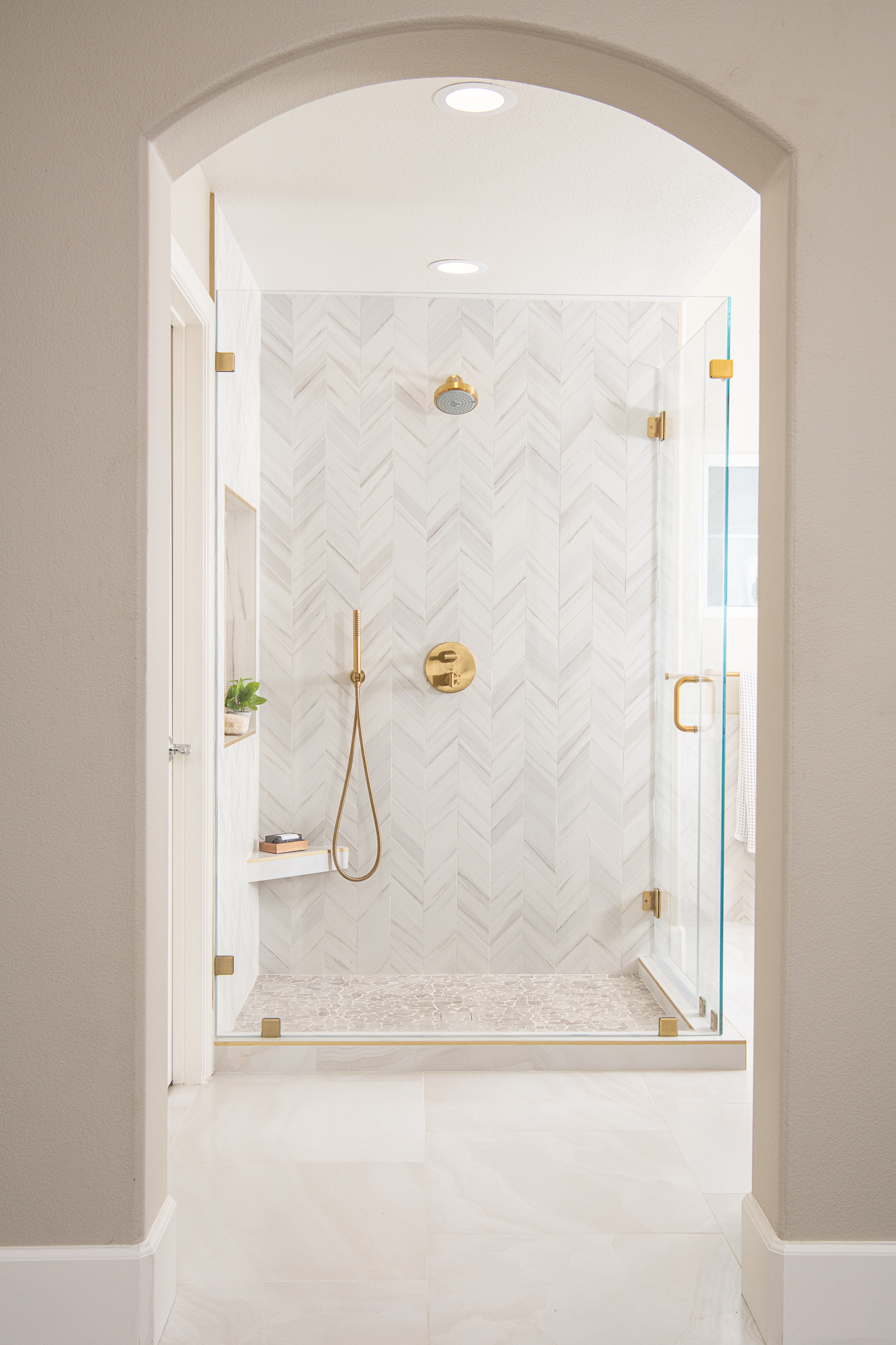 Master walk-in shower with marble chevron tile in Smyrna GA