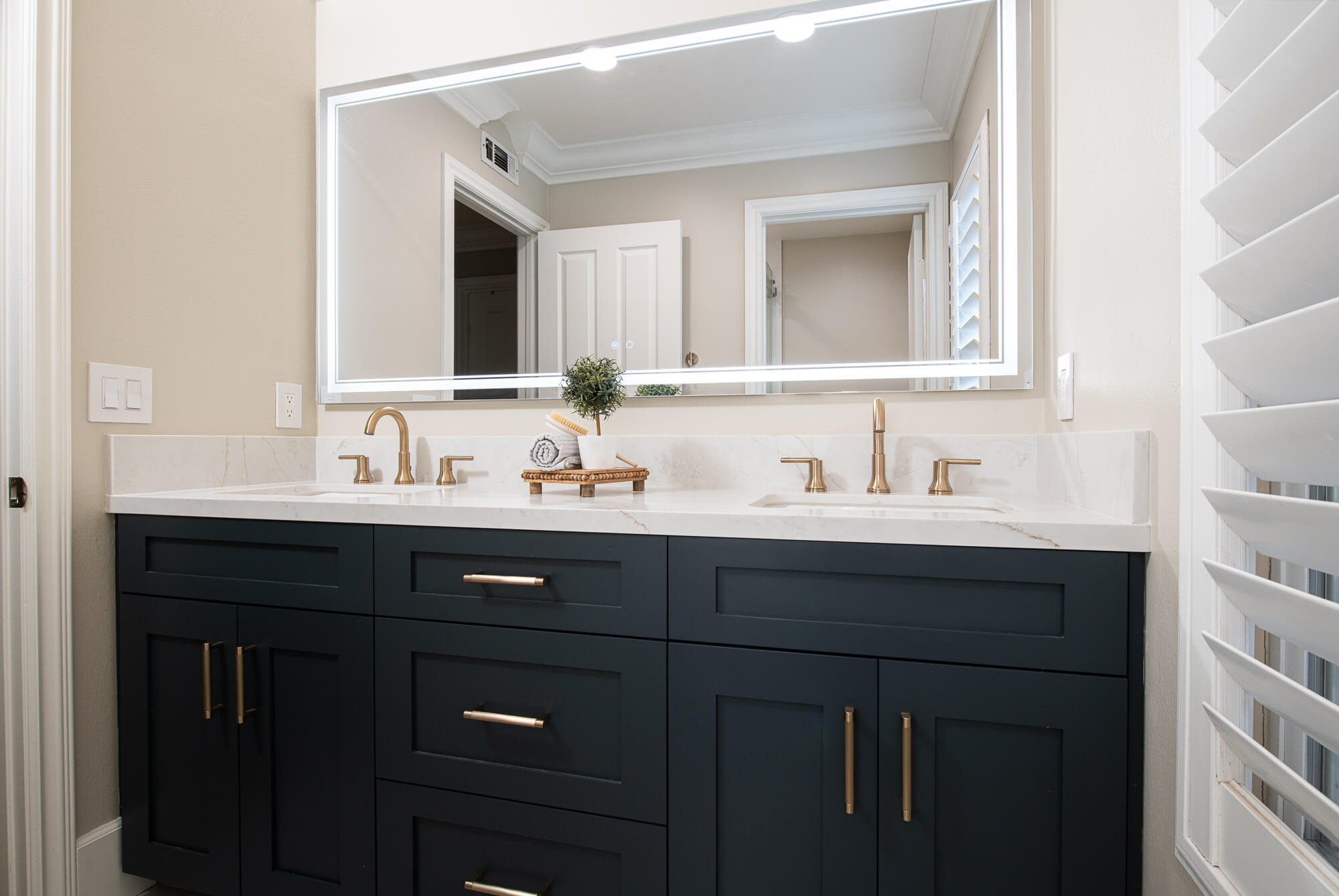 Secondary navy vanity wide with LED-backlit mirror