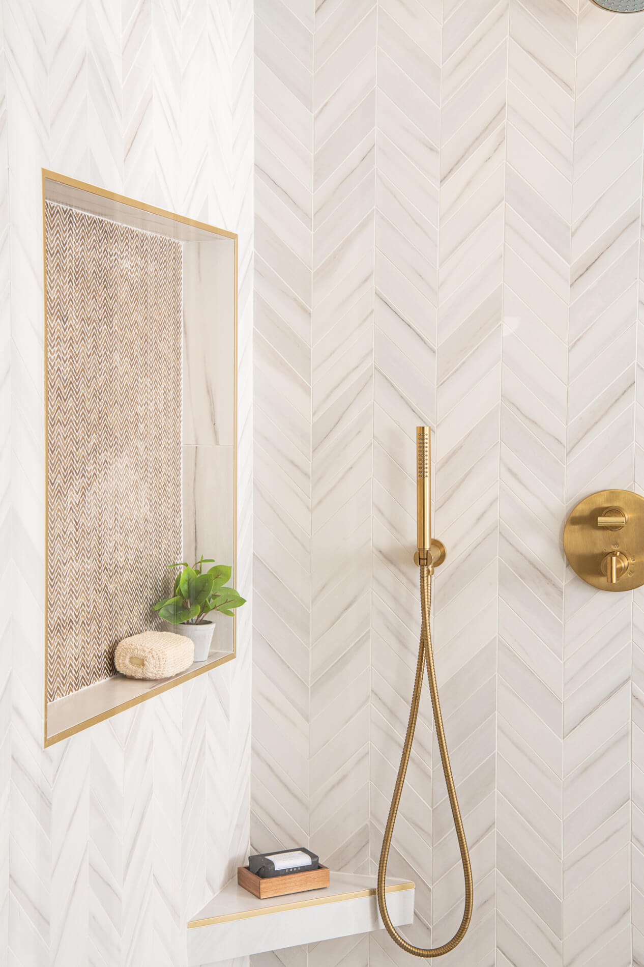 Brass-framed niche with herringbone gold backing