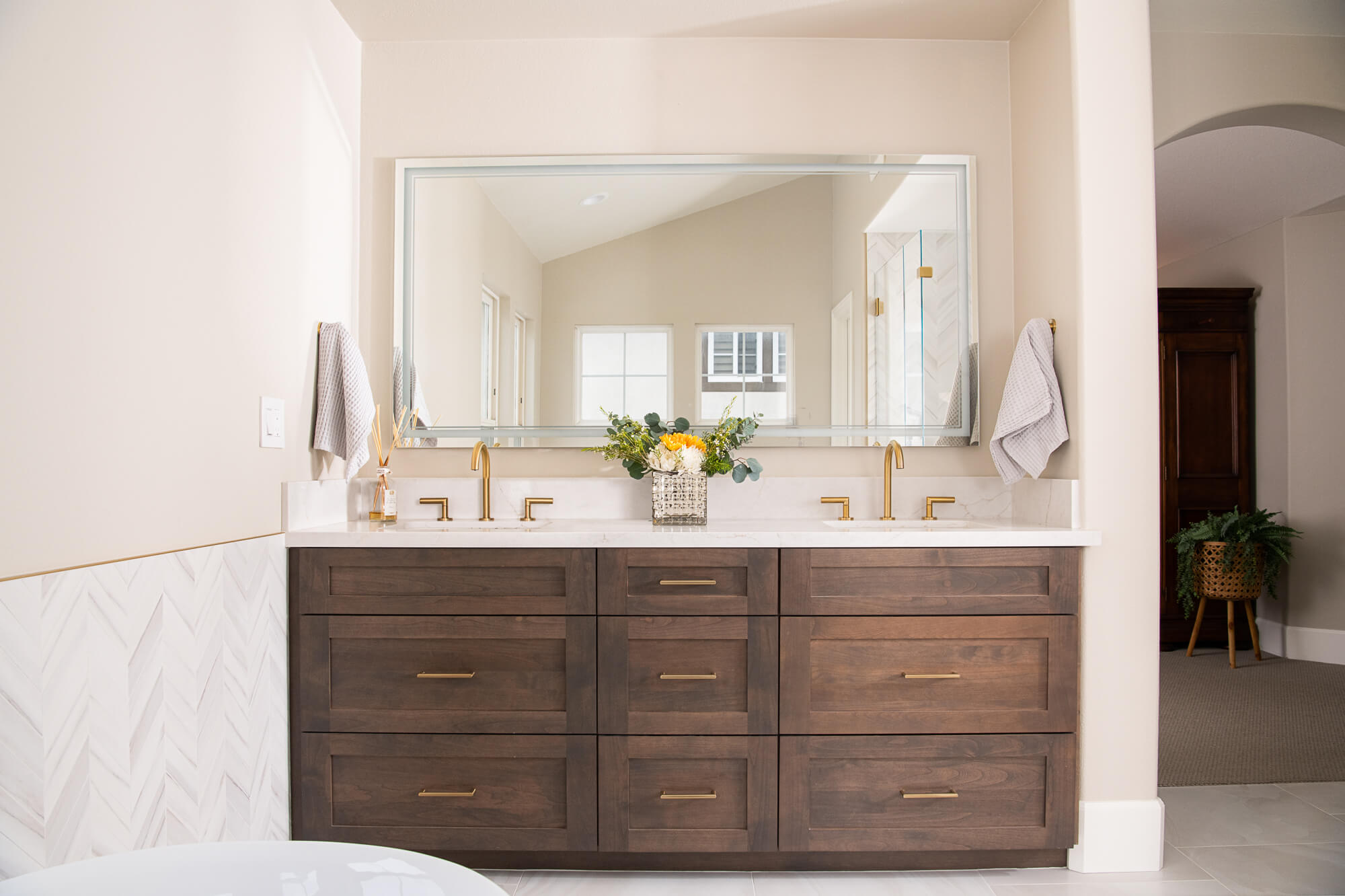 Secondary bath navy vanity with brass faucet and marble top