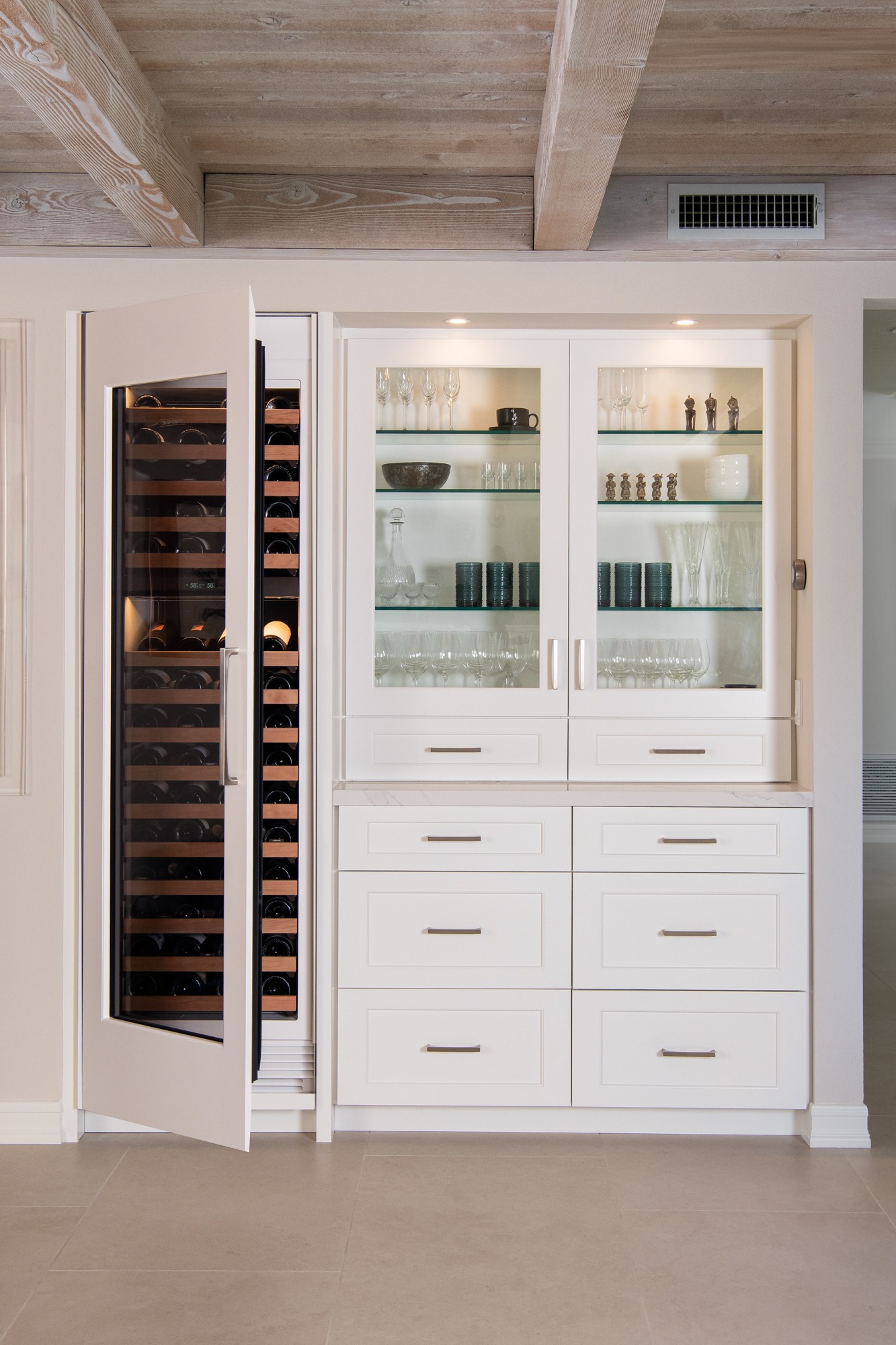 Custom butler bar with wine fridge and glass-front display cabinet