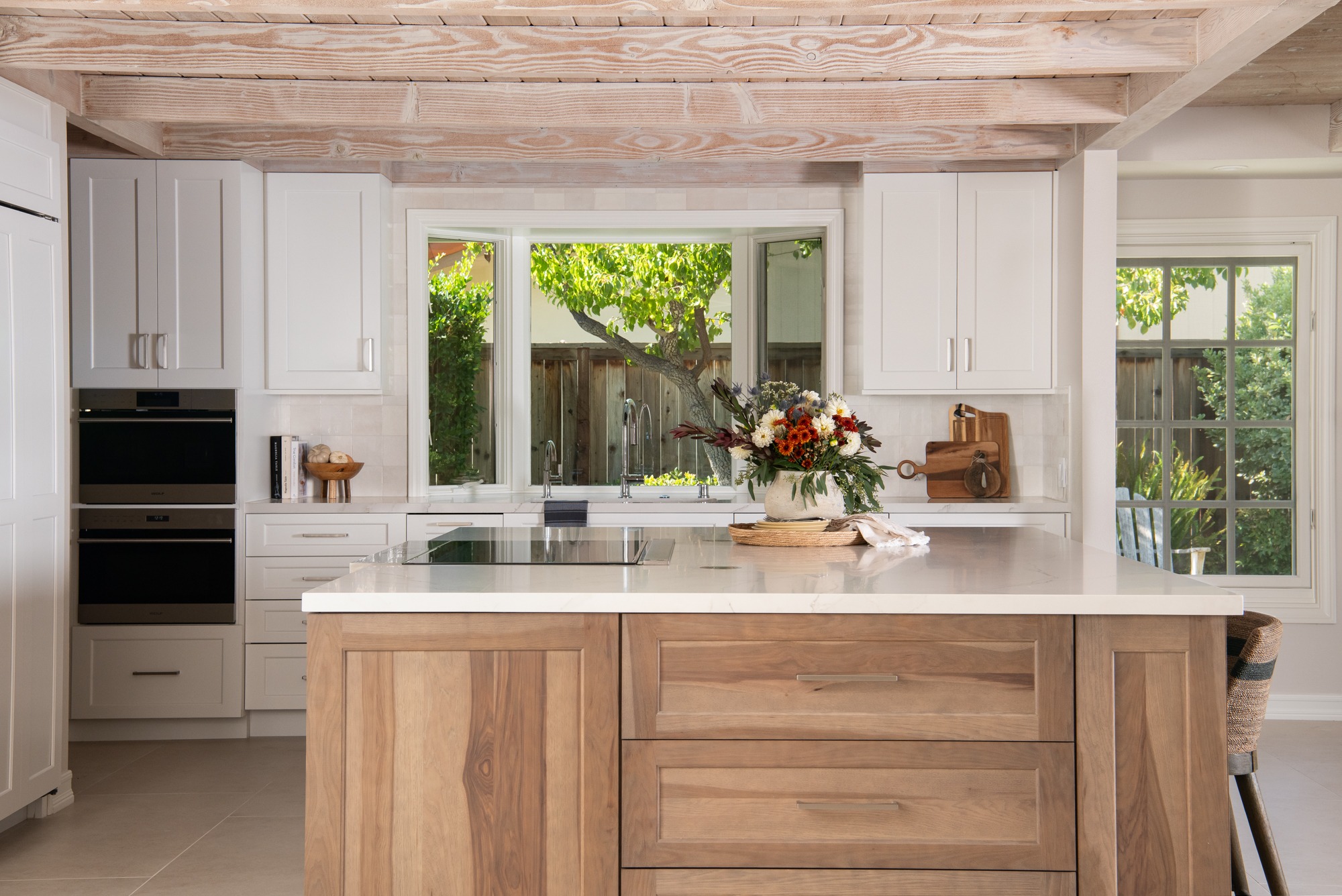 Coastal kitchen remodel in Roswell GA with walnut island and bay window over farmhouse sink