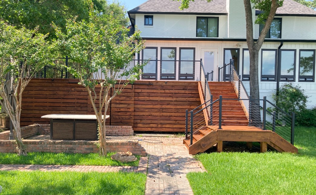 Stained wood deck with privacy rail against brick Atlanta home
