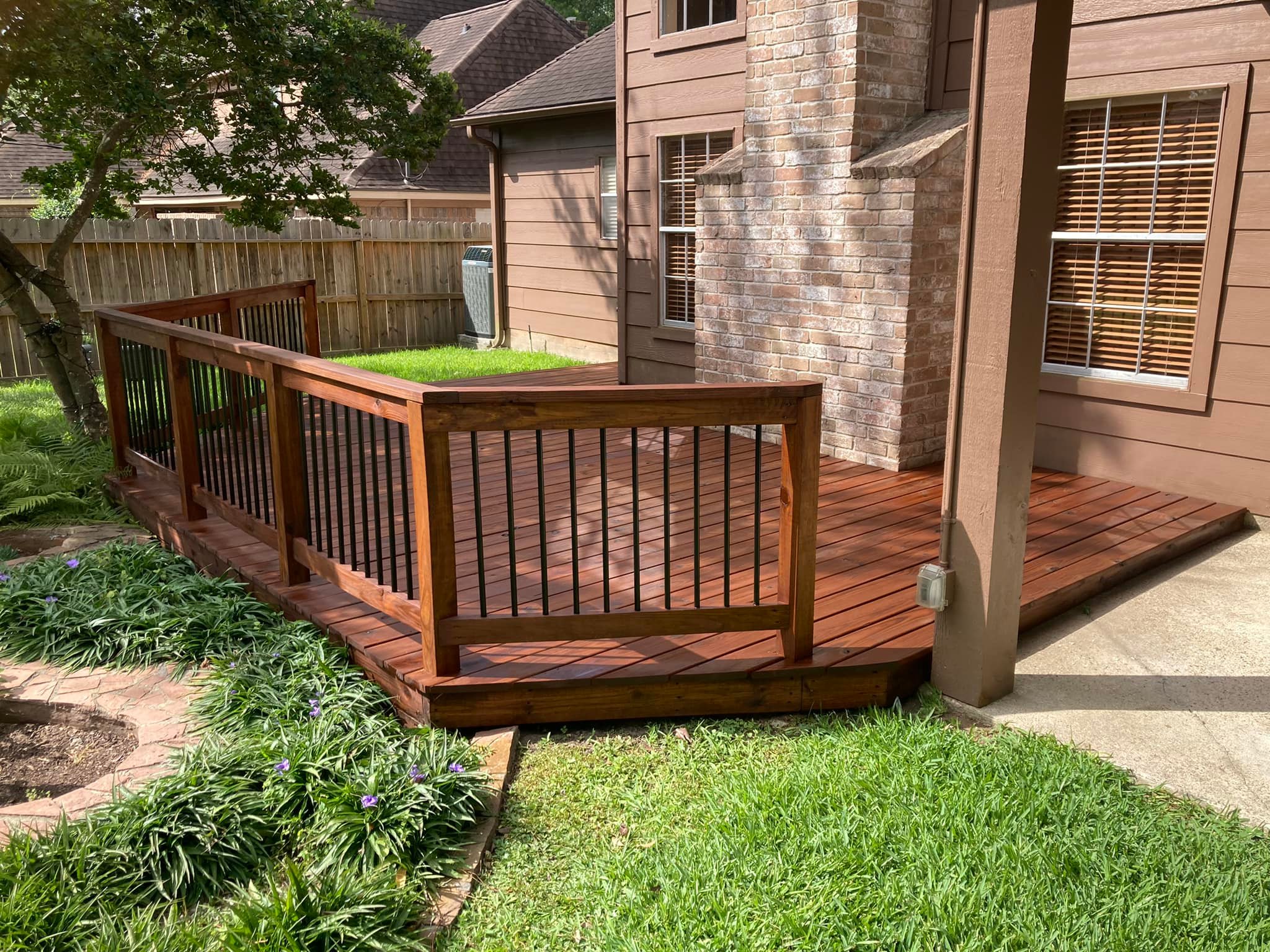 Wide multi-tier wood deck with broad steps leading to a lake house in Atlanta