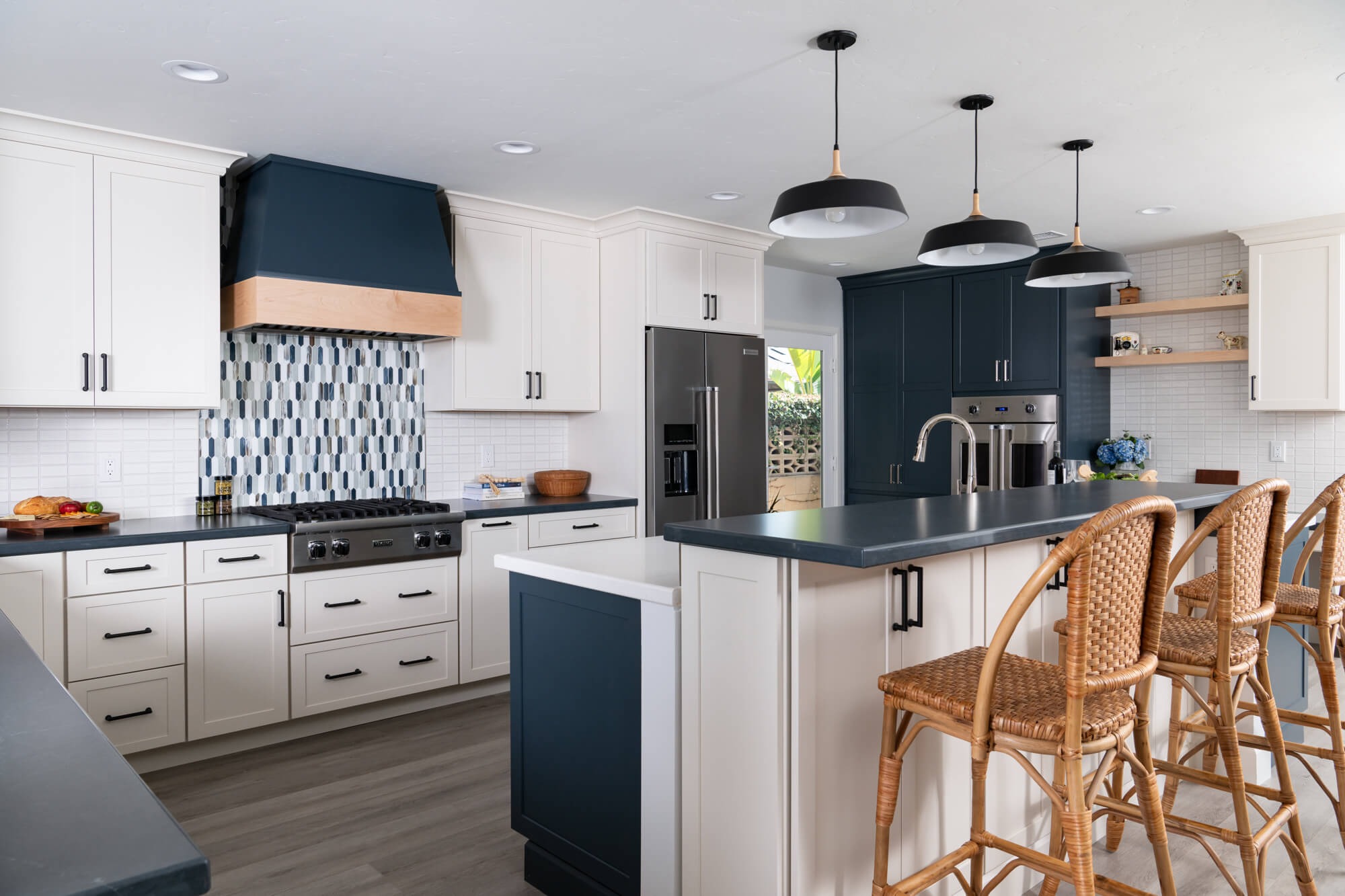 Island with farmhouse sink and warming drawer with ocean view