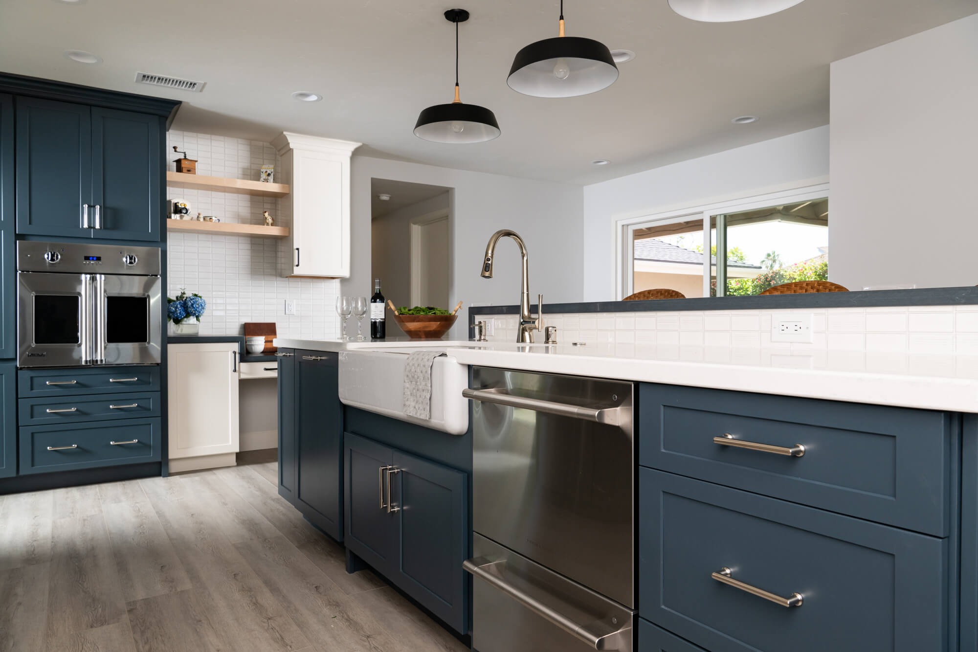 Navy cabinet stack with pro French-door wall oven and maple shelves