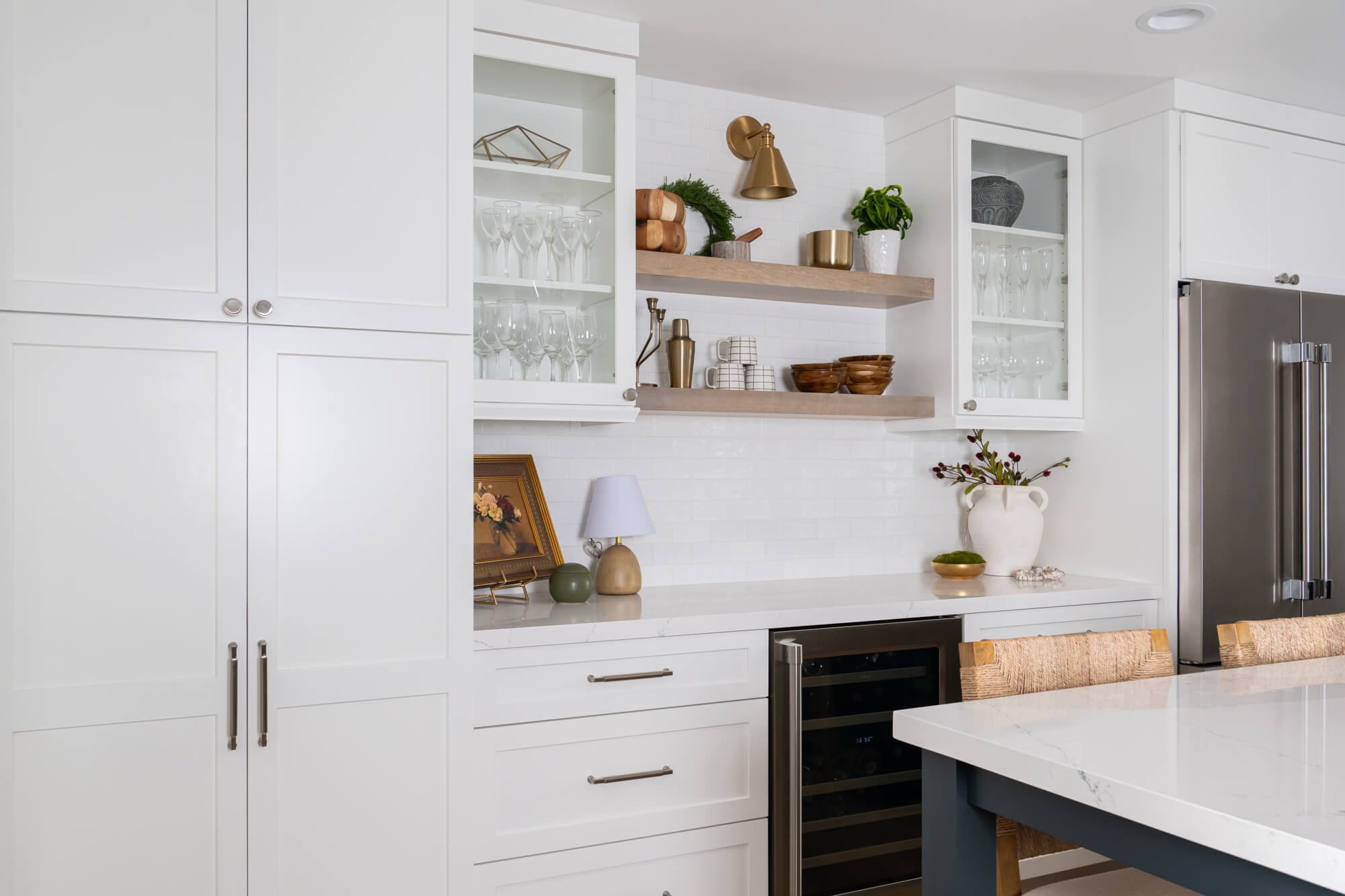 Open natural maple floating shelves over white subway tile in Sandy Springs kitchen