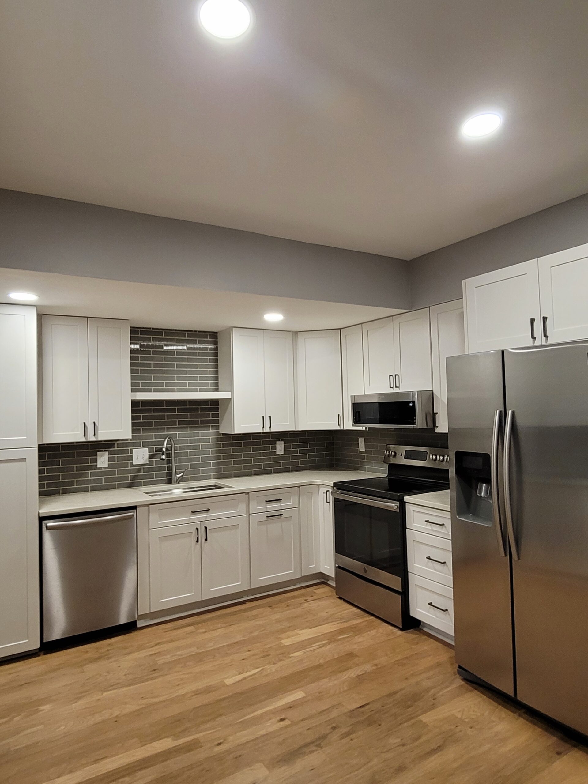 Kitchen renovation by Interior Transformation Remodeling in Metro Atlanta with white shaker cabinets and grey subway backsplash